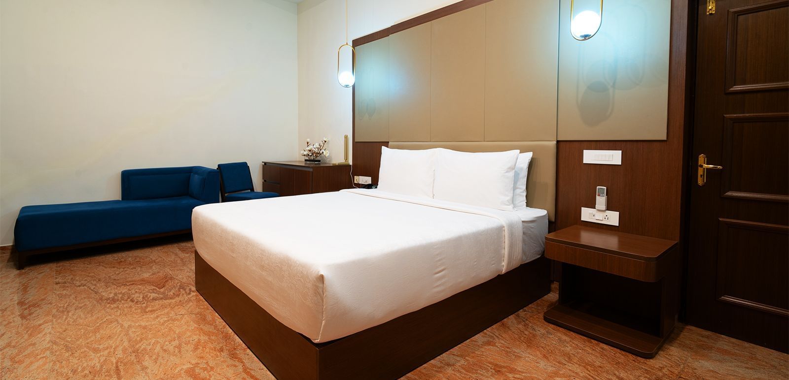 An image of a suite with a large bed, night stands, and lamps hanging from the ceilings - Accord Chrome Airport Hotel